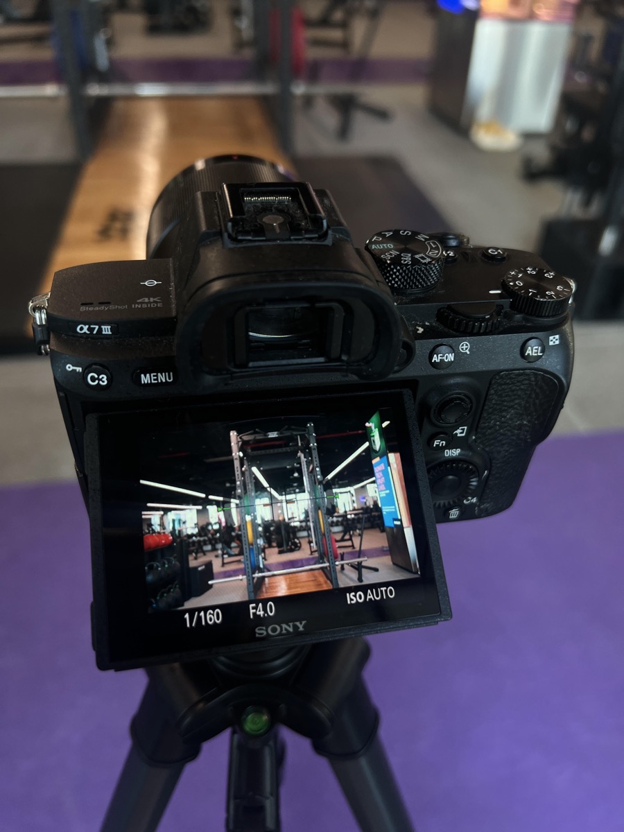 Sony camera on tripod filming a gym content shoot